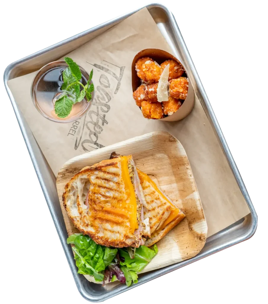 a tray with a sandwich and a bowl of dipping sauce