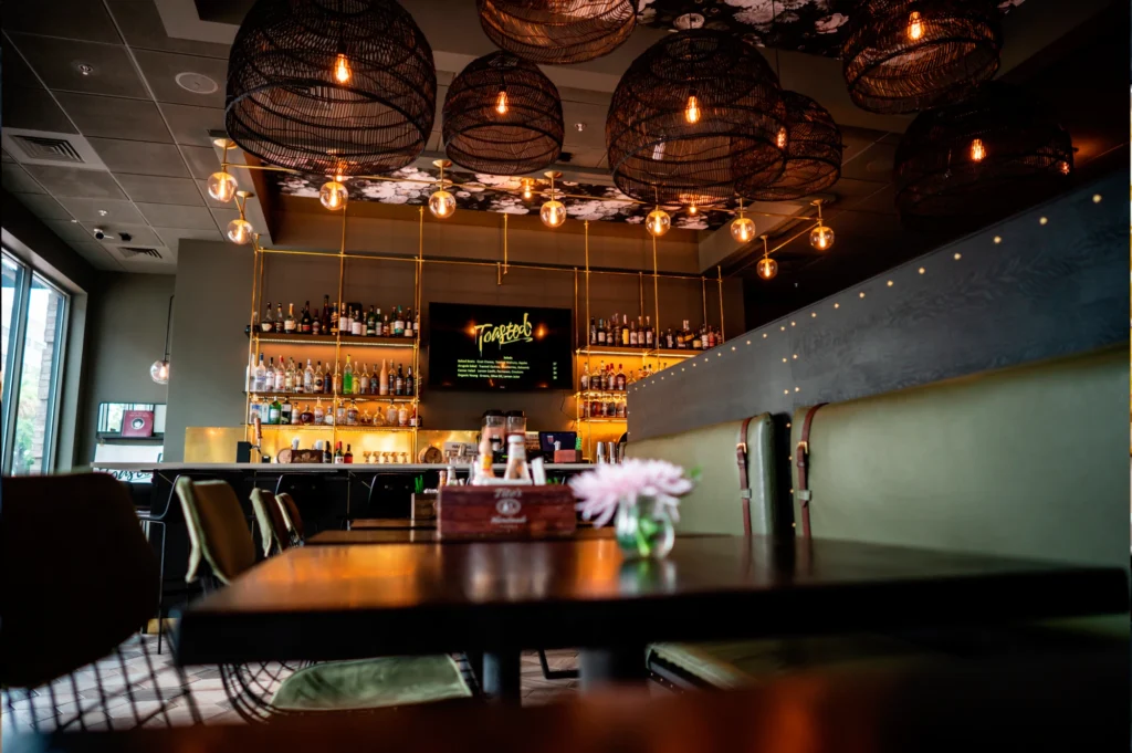 a dimly lit bar with a bunch of lights hanging from the ceiling