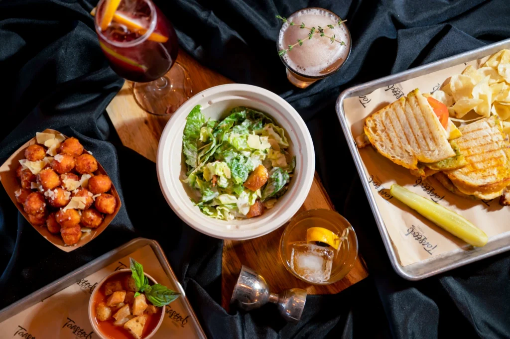a table topped with plates of food and drinks