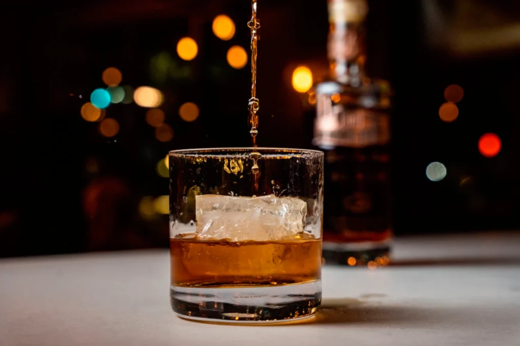 a glass filled with liquid sitting on top of a table