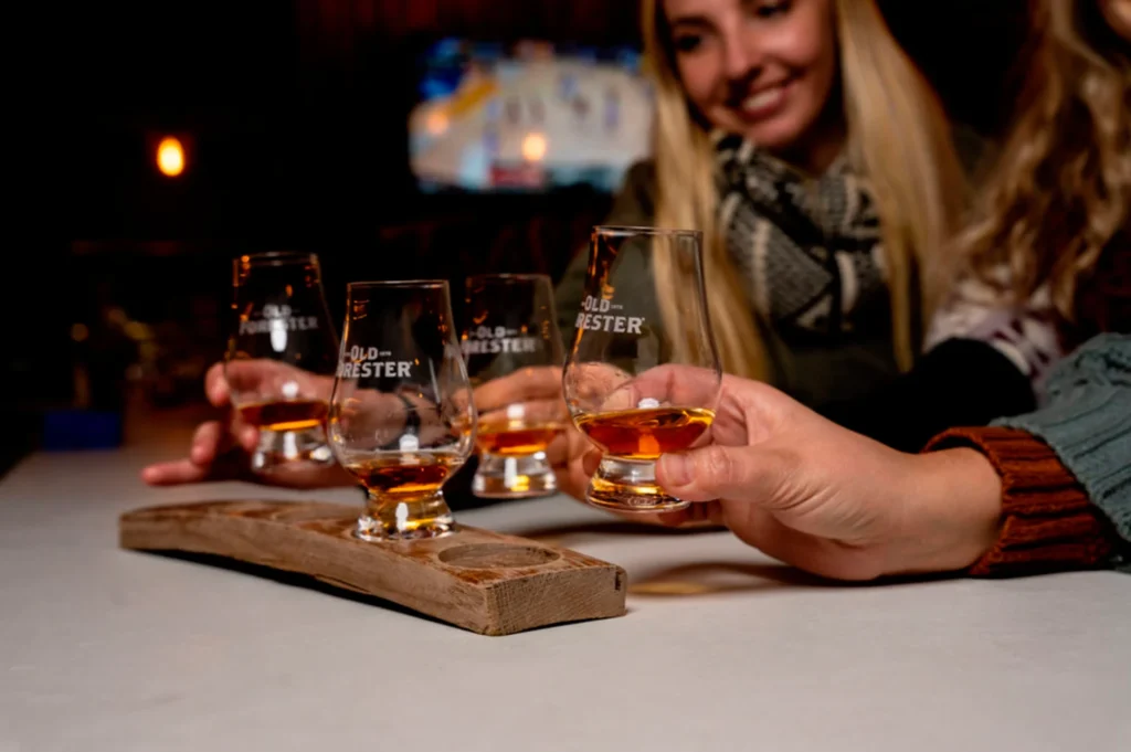 a group of people sitting at a table with glasses of alcohol